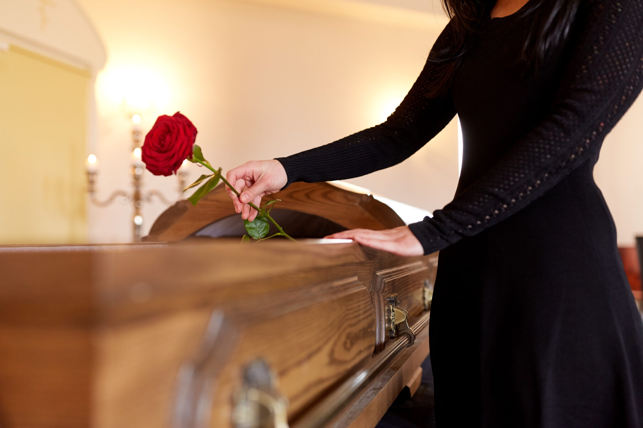 woman with red roses and coffin at funeral 2023 11 27 05 23 26 utc scaled